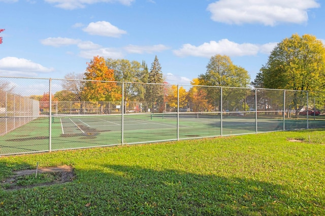 view of sport court featuring a yard