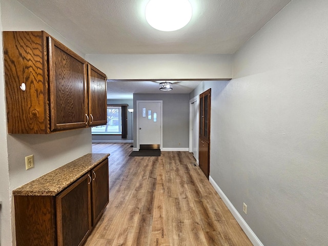 corridor with light hardwood / wood-style flooring