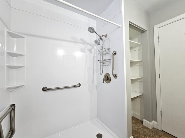 bathroom with a shower and tile patterned floors