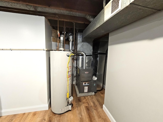 utility room featuring water heater