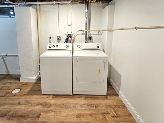 laundry area with hardwood / wood-style flooring and washer and dryer