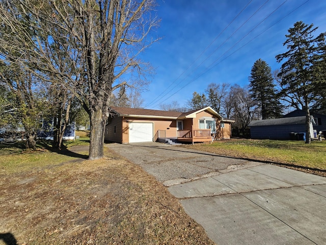 single story home featuring a deck, a front lawn, and a garage