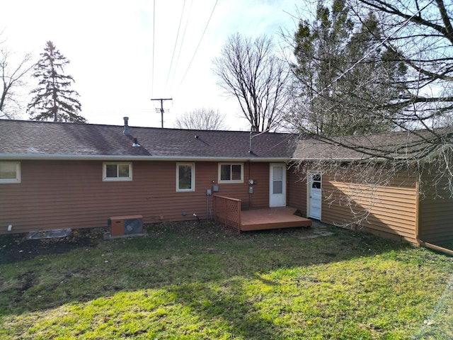 rear view of house featuring a yard and a wooden deck