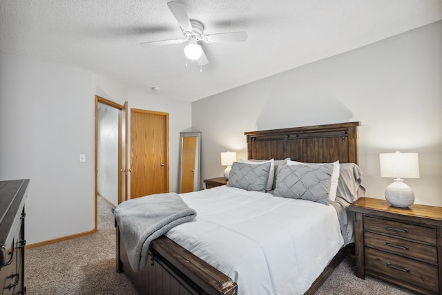 bedroom featuring dark colored carpet, ceiling fan, and a textured ceiling