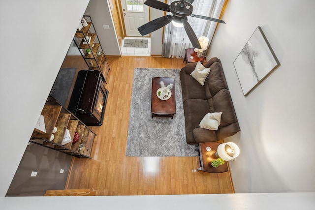 living room featuring hardwood / wood-style floors and ceiling fan