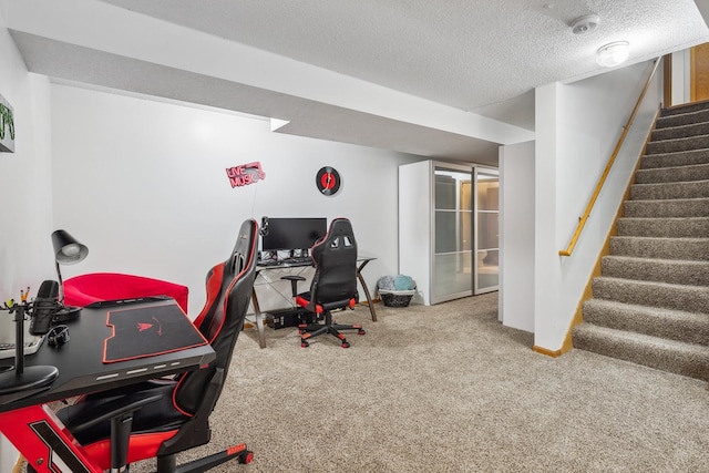 carpeted home office with a textured ceiling