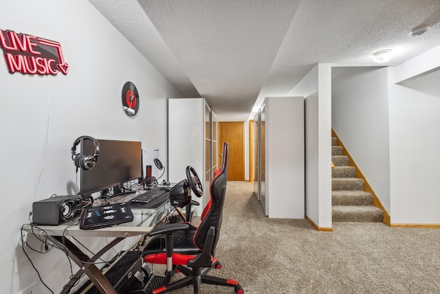 carpeted home office featuring a textured ceiling