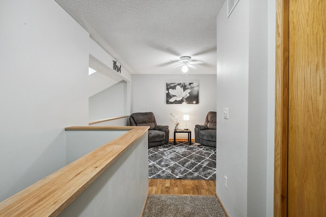 hallway featuring hardwood / wood-style flooring and a textured ceiling