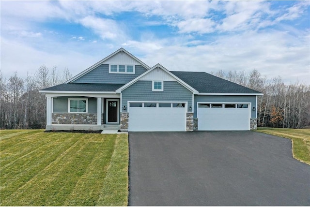 craftsman-style house featuring a front lawn and a garage