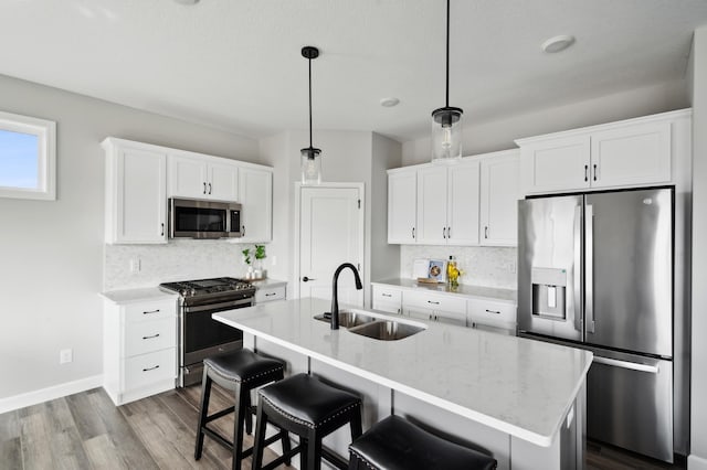 kitchen with white cabinets, sink, and appliances with stainless steel finishes