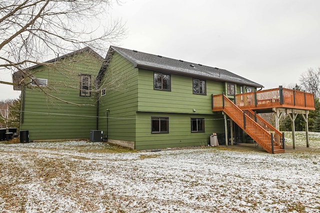 snow covered property featuring a deck and central air condition unit