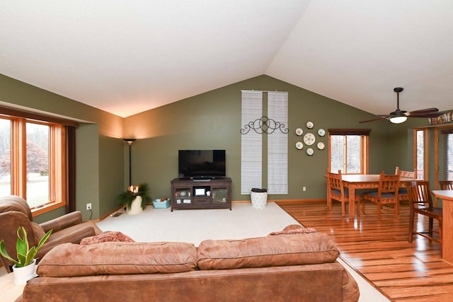 living room featuring hardwood / wood-style floors, ceiling fan, and lofted ceiling