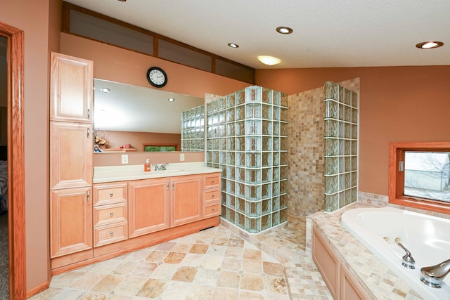 bathroom featuring a textured ceiling, vanity, independent shower and bath, and lofted ceiling