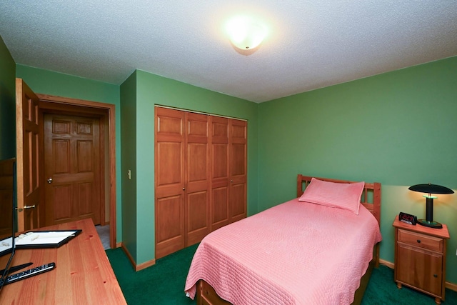 bedroom with dark colored carpet, a textured ceiling, and a closet