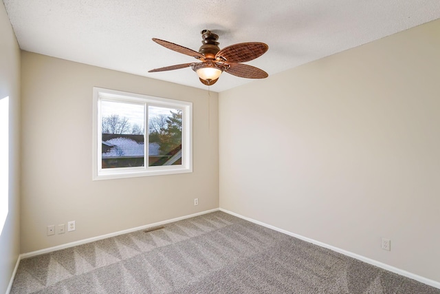 empty room featuring carpet flooring, ceiling fan, and a textured ceiling