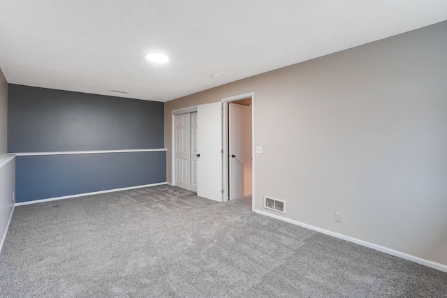 unfurnished bedroom with carpet flooring and a closet