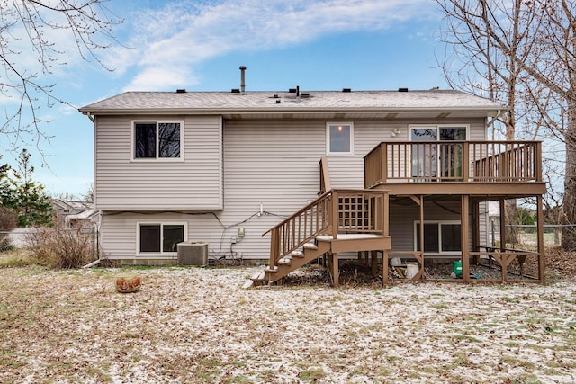 rear view of house featuring central AC unit and a wooden deck