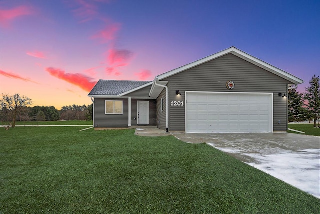 single story home with a yard and a garage