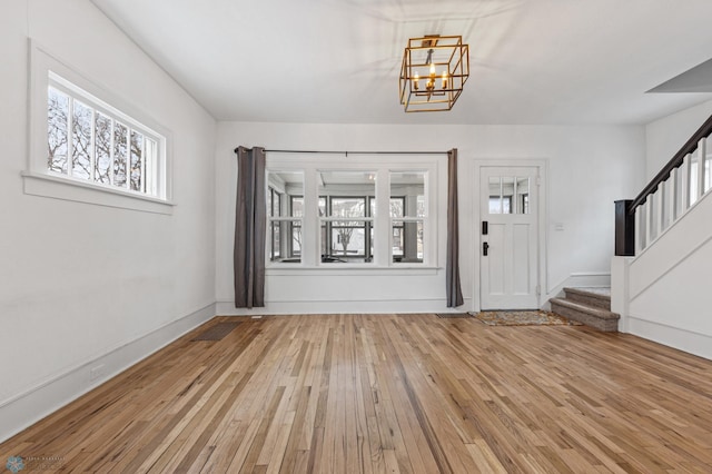 1018 11th St S, Fargo, ND 58103 - entrance foyer featuring stairway, hardwood / wood-style floors, and a chandelier