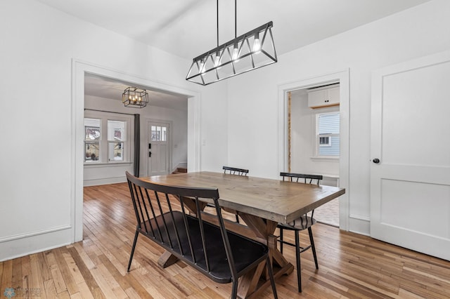 dining room with an inviting chandelier and light wood-type flooring