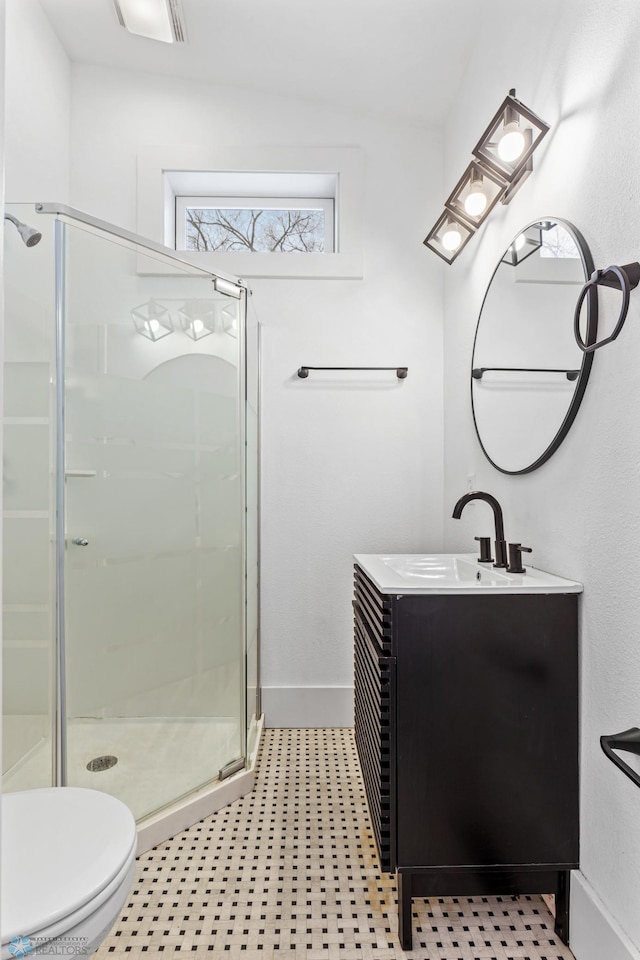 bathroom featuring vanity, toilet, and an enclosed shower