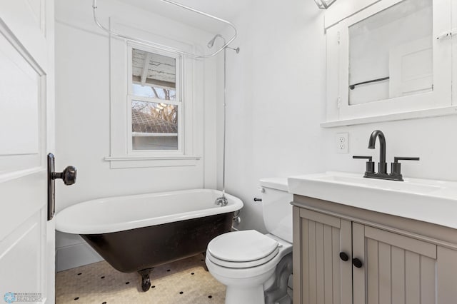 bathroom with vanity, a bathtub, and toilet