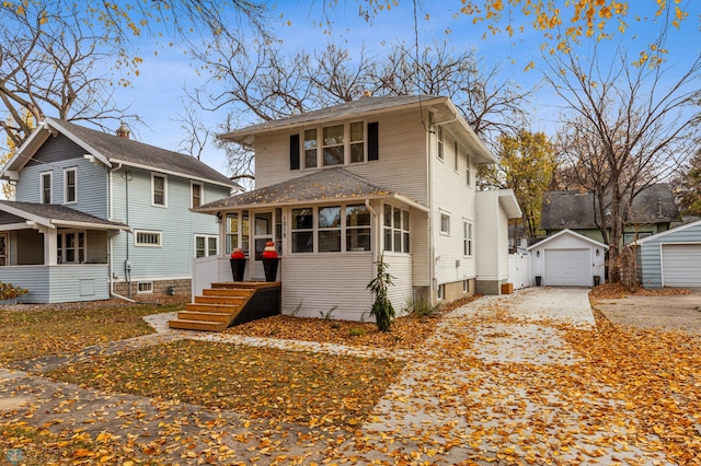 1018 11th St S, Fargo, ND 58103 - american foursquare style home with driveway, an outdoor structure, a detached garage, and a sunroom