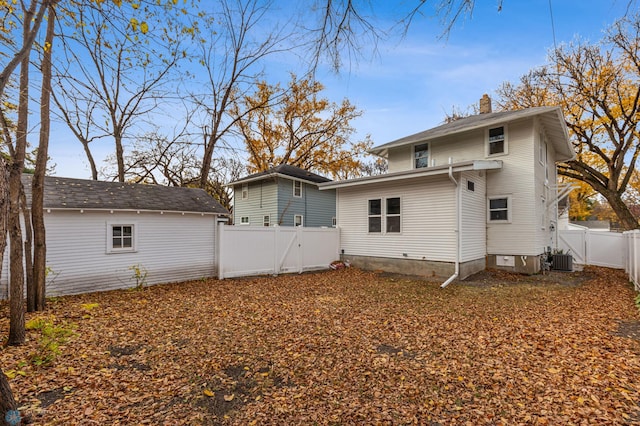 rear view of property featuring central AC unit