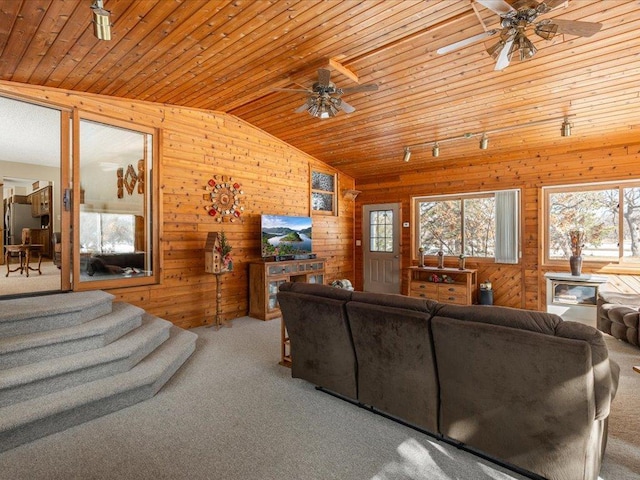 carpeted living area with wooden ceiling, ceiling fan, and vaulted ceiling