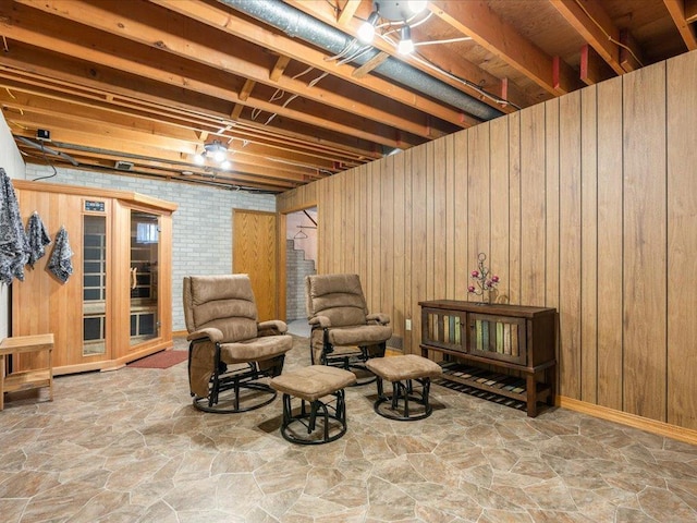 sitting room with wooden walls and stone floors