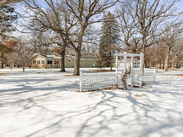 yard covered in snow featuring a fenced front yard