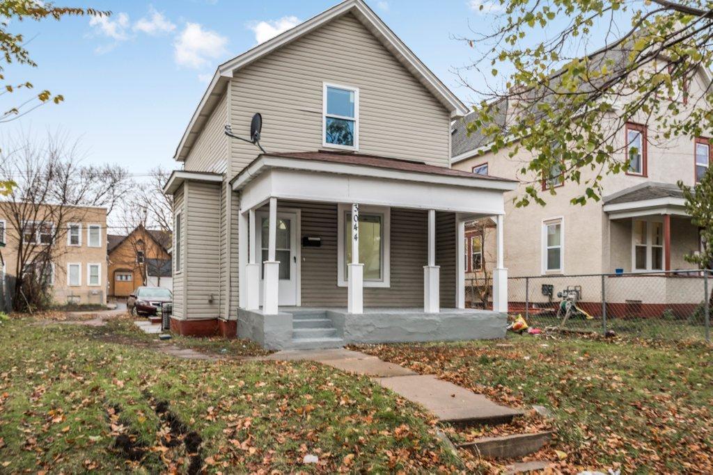 view of front of property with covered porch and a front yard