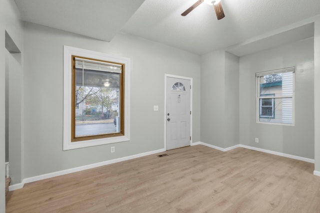 entrance foyer featuring ceiling fan, light wood-type flooring, and a textured ceiling