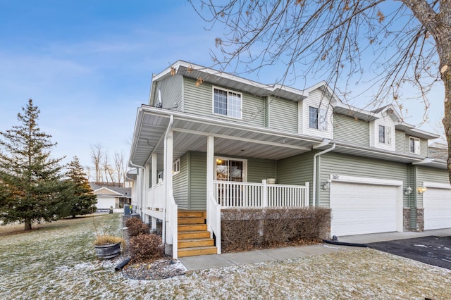 view of front of property with a porch and a garage