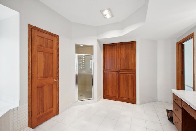 full bathroom featuring a shower stall, baseboards, and vanity