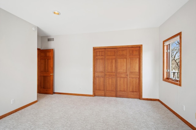 unfurnished bedroom with recessed lighting, carpet floors, visible vents, and baseboards