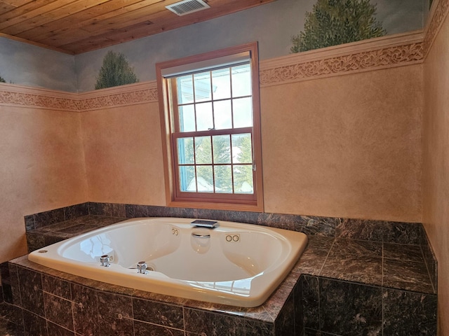 bathroom with wooden ceiling and tiled bath