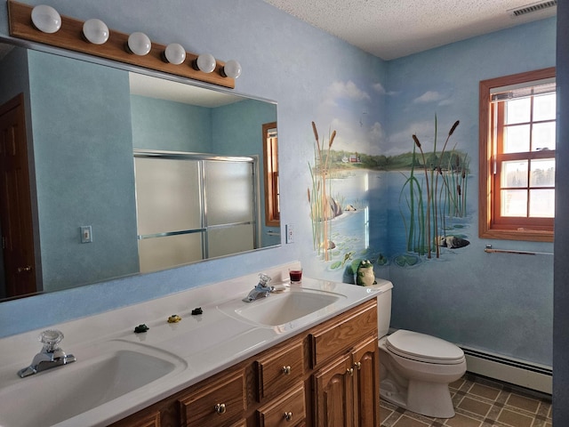 bathroom with vanity, a textured ceiling, a baseboard heating unit, toilet, and a shower with shower door