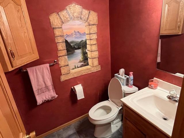 bathroom featuring tile patterned flooring, vanity, and toilet