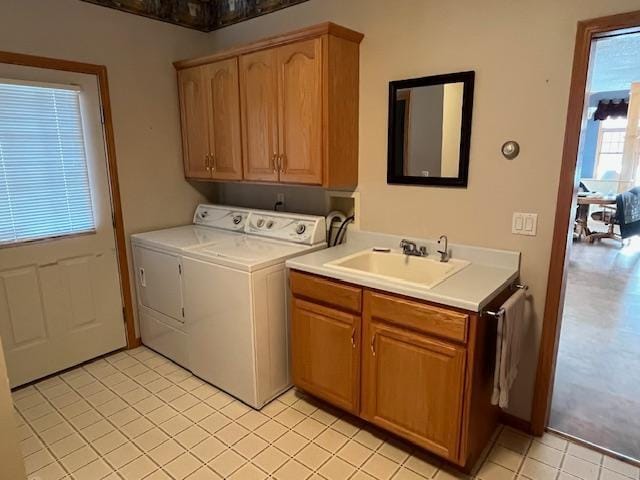 laundry room with cabinets, sink, light tile patterned floors, and washer and dryer