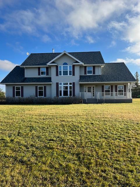 view of front facade featuring a front lawn and covered porch