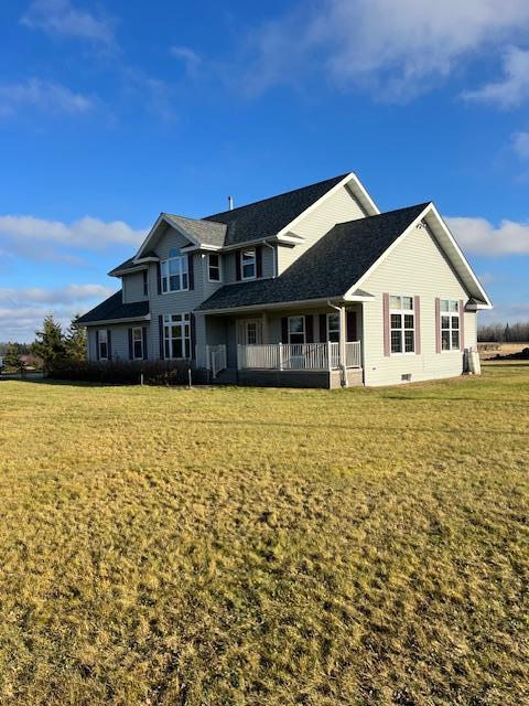 rear view of property with a lawn