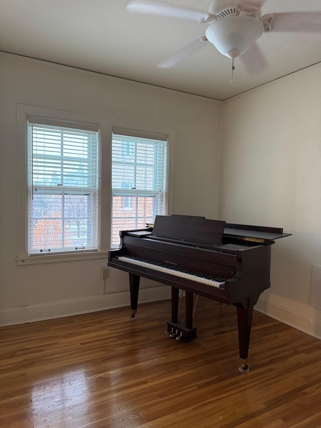 miscellaneous room with ceiling fan and dark wood-type flooring