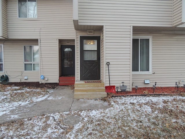 view of snow covered property entrance