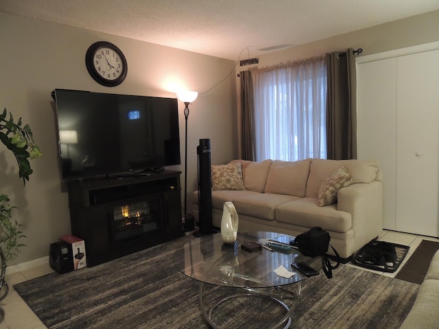 living room with tile patterned floors and a textured ceiling