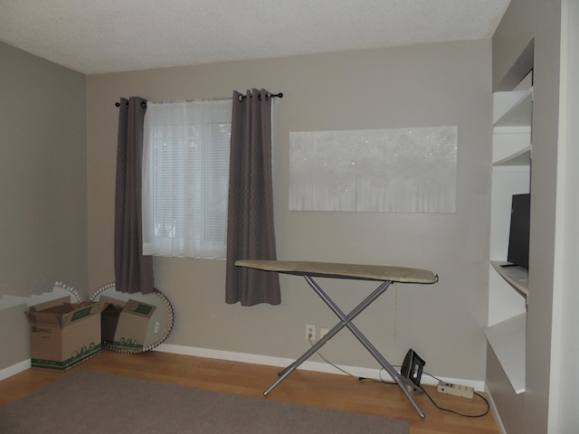 misc room with hardwood / wood-style floors and a textured ceiling