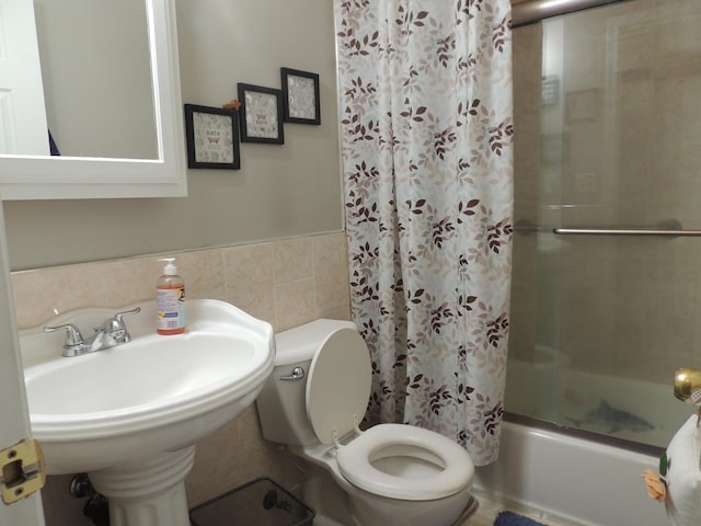 bathroom featuring toilet, shower / bathtub combination with curtain, and tile walls