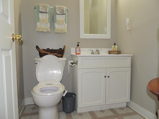 bathroom featuring tile patterned flooring, vanity, and toilet