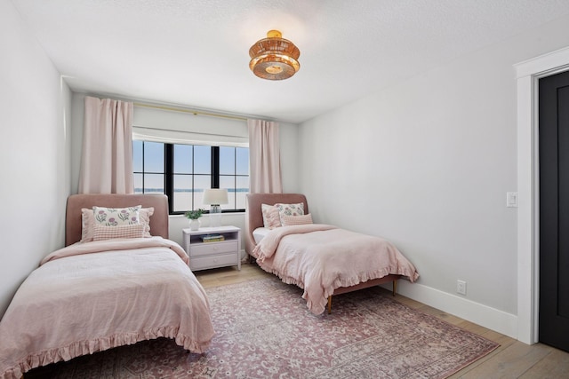 bedroom with wood finished floors and baseboards