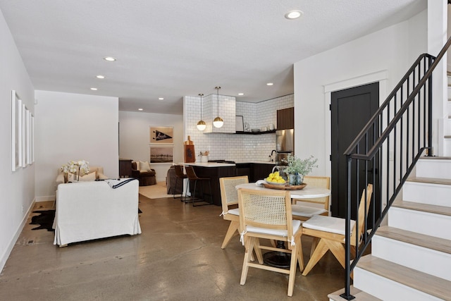 dining area featuring baseboards, concrete floors, recessed lighting, stairs, and a textured ceiling